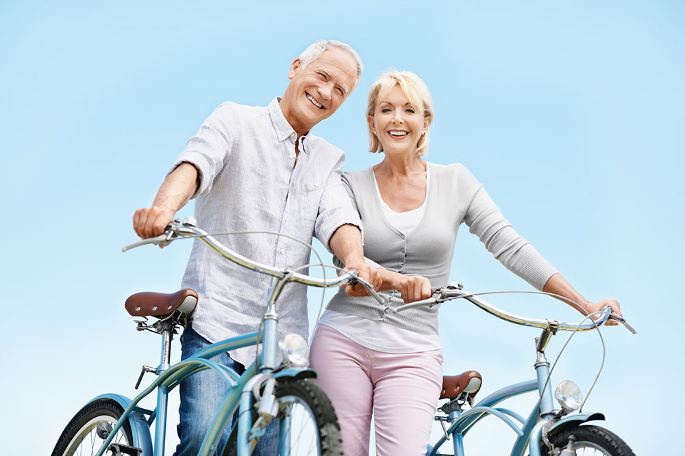 smiling senior couple on bikes
